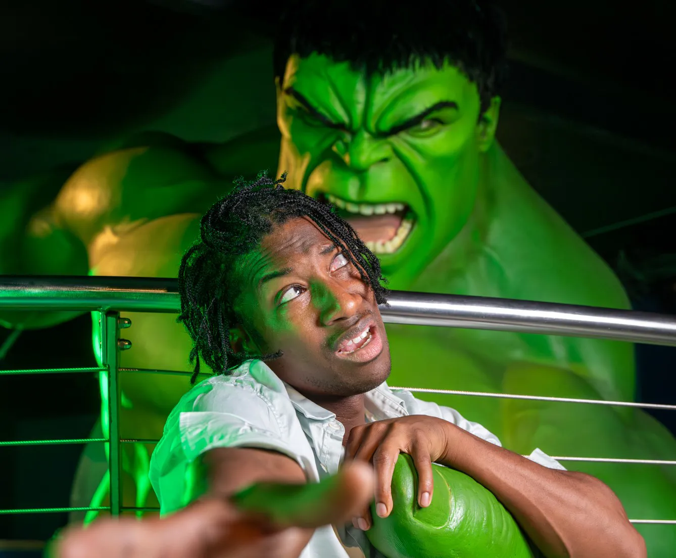 A person reaching out for help as they are being grabbed by The Incredible Hulk